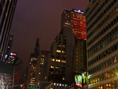 Nighttime city street with skyscrapers and neon lights