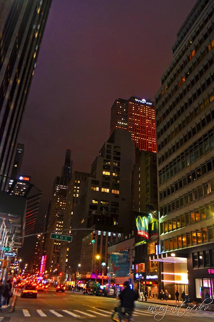 Nighttime city street with skyscrapers and neon lights