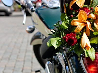 Motorcycle decorated with orange lilies and red roses