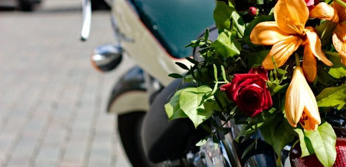 Motorcycle decorated with orange lilies and red roses