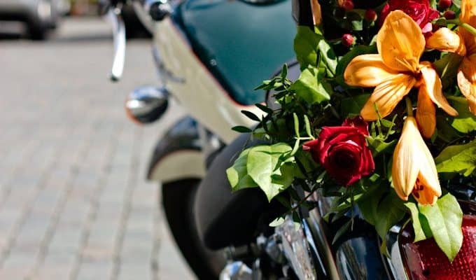 Motorcycle decorated with orange lilies and red roses