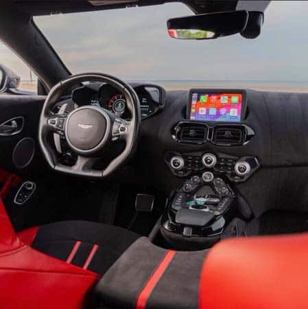 Luxury sports car interior with red seats and dashboard