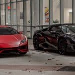 Red and black Lamborghini sports cars parked outside.