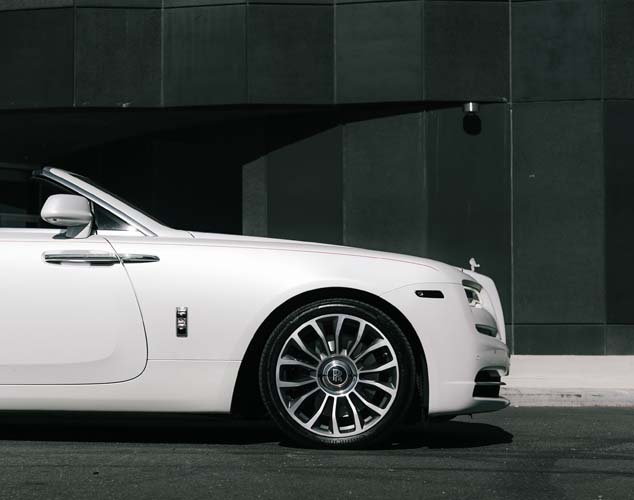 White luxury car front side view with alloy wheel
