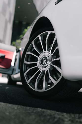 Close-up of Rolls-Royce wheel on white car