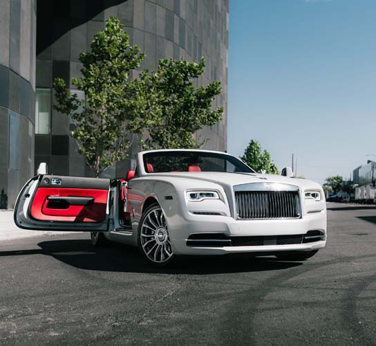 White Rolls-Royce convertible with red interior, door open