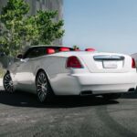 White luxury convertible with red interior parked outside