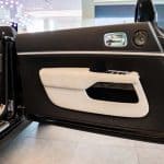 Luxury car interior door panel with leather trim