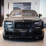 Front view of black Rolls-Royce in showroom