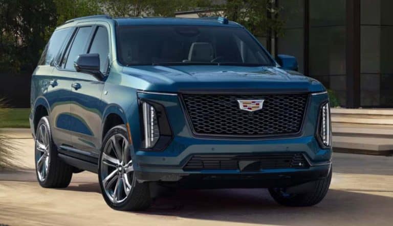 Blue Cadillac SUV parked outside modern building