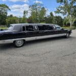 Black stretch limousine parked on residential driveway