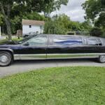 Long black stretch limousine parked on suburban street