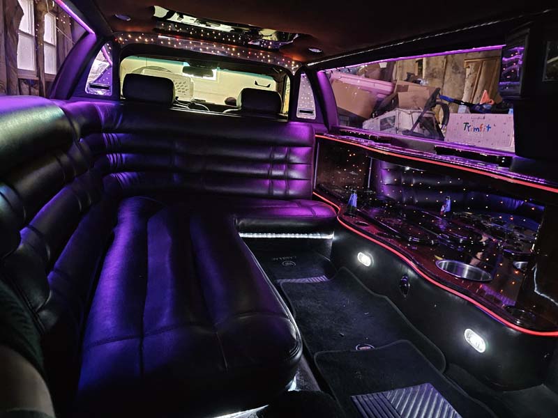 Luxury limousine interior with purple ambient lighting