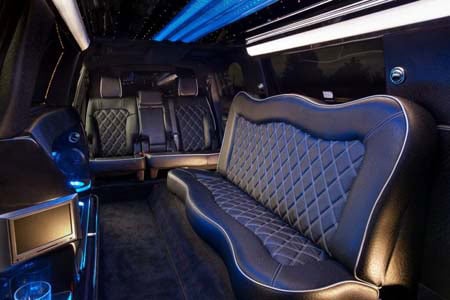 Luxury limousine interior with leather seats and blue lighting