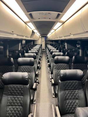Empty passenger train car with black leather seats