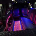 Luxury limo interior with starlight ceiling and neon lighting.