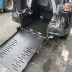 Wheelchair ramp extended from rear of van