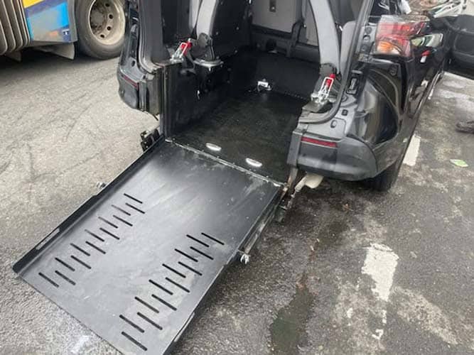 Wheelchair ramp extended from rear of van