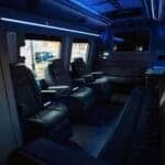 Luxury van interior with leather seats and blue lighting