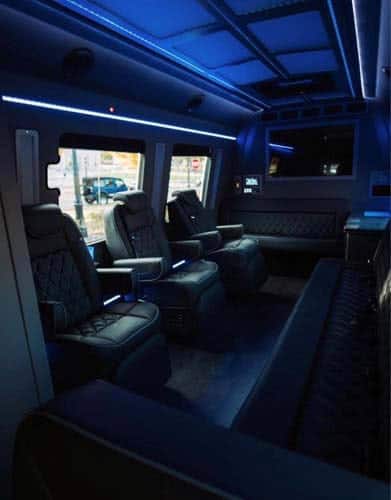 Luxury van interior with leather seats and blue lighting