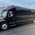 Large black luxury party bus parked outdoors