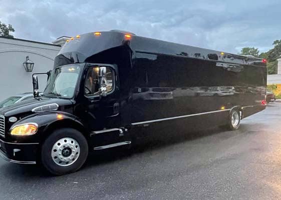 Large black luxury party bus parked outdoors