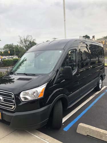 Black passenger van parked in accessible parking space
