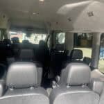 Interior of passenger van with multiple rows of seats