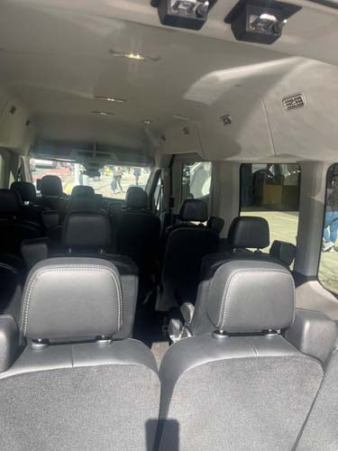 Interior of passenger van with multiple rows of seats