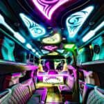Neon-lit luxury limousine interior with colorful LED ceiling