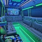 Neon-lit luxury party bus interior with leather seating