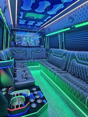Neon-lit luxury party bus interior with leather seating