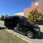 Black Mercedes-Benz Sprinter van parked in front of brick building