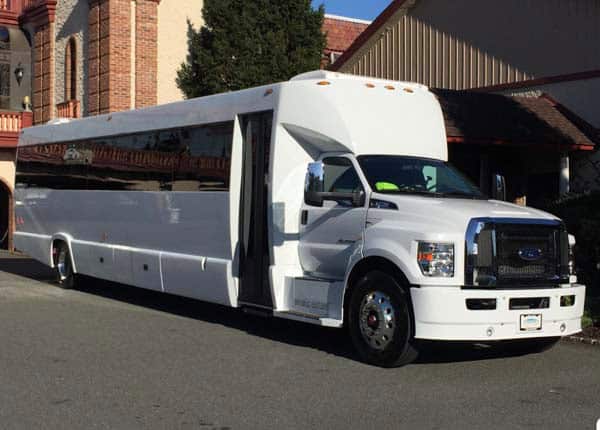 White stretch limousine bus parked outside building