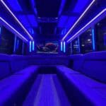 Blue neon-lit luxury limousine interior with leather seats