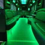 Green neon-lit luxury party bus interior seating