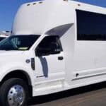 White stretch limousine bus parked outdoors