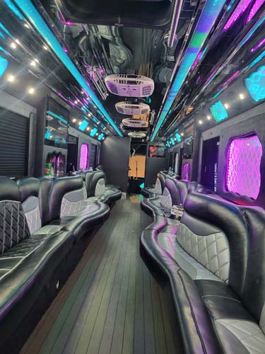 Luxury party bus interior with neon lights and leather seats