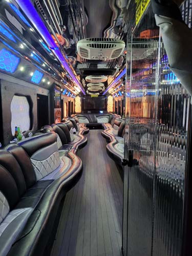 Luxury party bus interior with neon lights and seating