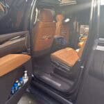 Open SUV door revealing tan leather interior seats