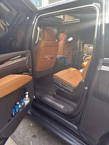 Open SUV door revealing tan leather interior seats
