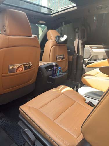 Luxury SUV interior with tan leather seats and sunroof