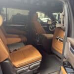 Tan leather interior of luxury SUV with captain seats