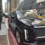 Black luxury SUV parked on city street