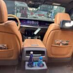 Luxury car interior with tan leather seats and city view