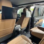 Luxury SUV interior with tan leather seats and rear screen
