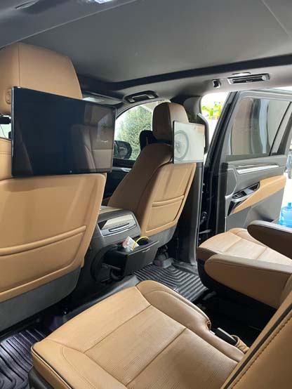 Luxury SUV interior with tan leather seats and rear screen