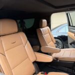 Tan leather captain's chairs inside luxury minivan
