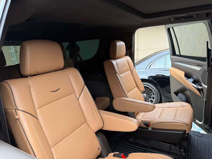 Tan leather captain's chairs inside luxury minivan