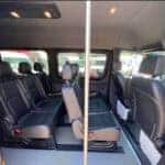 Interior of passenger van with multiple rows of seats
